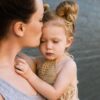幼児期の子が大人に支えられながら一緒に謝ろうとする姿
